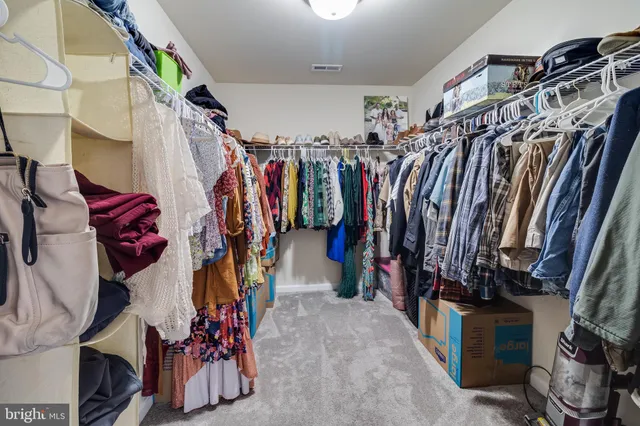 a bathroom with a toilet sink double vanity and mirror