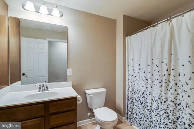 a view of a house with backyard and a garden