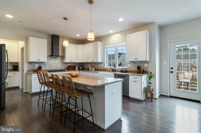 a kitchen with a center island appliances and cabinets