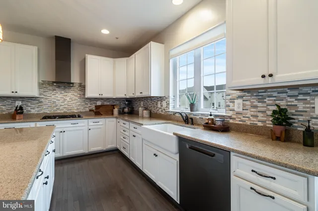 a kitchen with stainless steel appliances granite countertop a refrigerator sink and stove