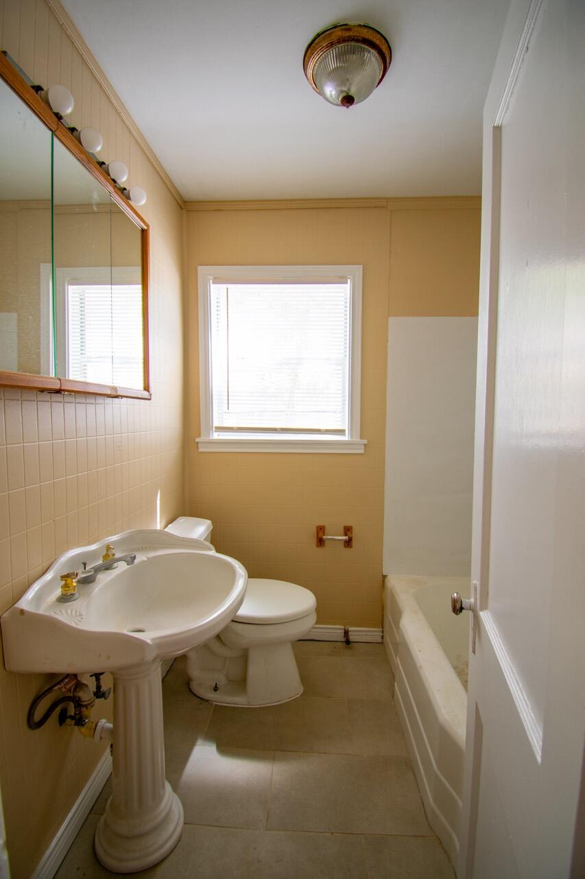 2424 27th Street Lubbock, TX 79411 - Photo 10 of 14 a bathroom with a sink and a toilet