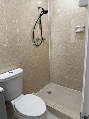 a bathroom with a sink toilet and mirror