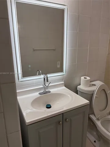 a bathroom with a toilet a sink and bathtub