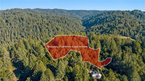 an aerial view of a house with a yard and lake view