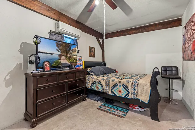 a bed sitting in a bedroom next to a window