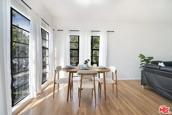 a kitchen with stainless steel appliances white cabinets and a refrigerator