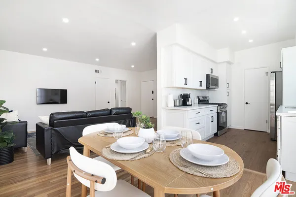 a kitchen with stainless steel appliances granite countertop a stove and a white cabinets