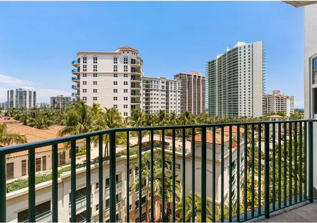 a bedroom with a bed and a flat tv screen on dresser