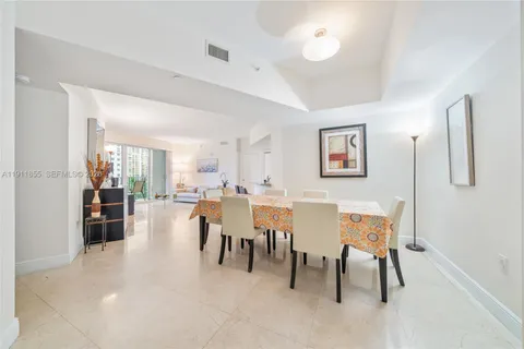 a dining room with furniture and a view of kitchen