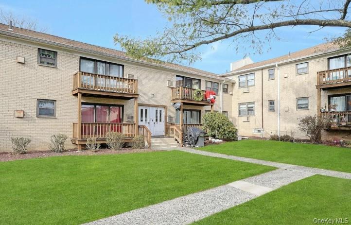 285 Sneden Place West, Unit 285 Spring Valley, NY 10977 - Photo 1 of 7 a front view of a house with a yard and porch