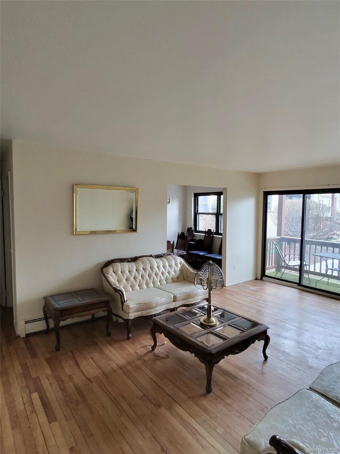 285 Sneden Place West, Unit 285 Spring Valley, NY 10977 - Photo 5 of 7 a living room with furniture and a wooden floor