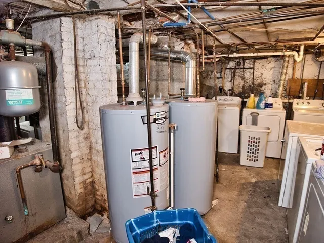 a view of a storage & utility room with refrigerator and washer