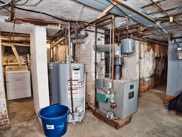 a view of a storage room with water heater and racks