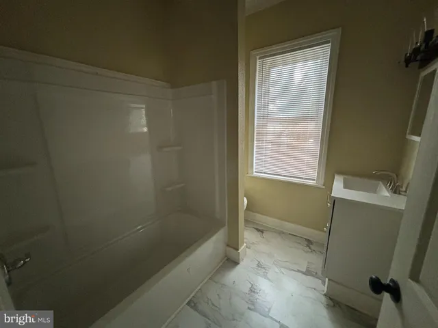 a bathroom with a bathtub and shower
