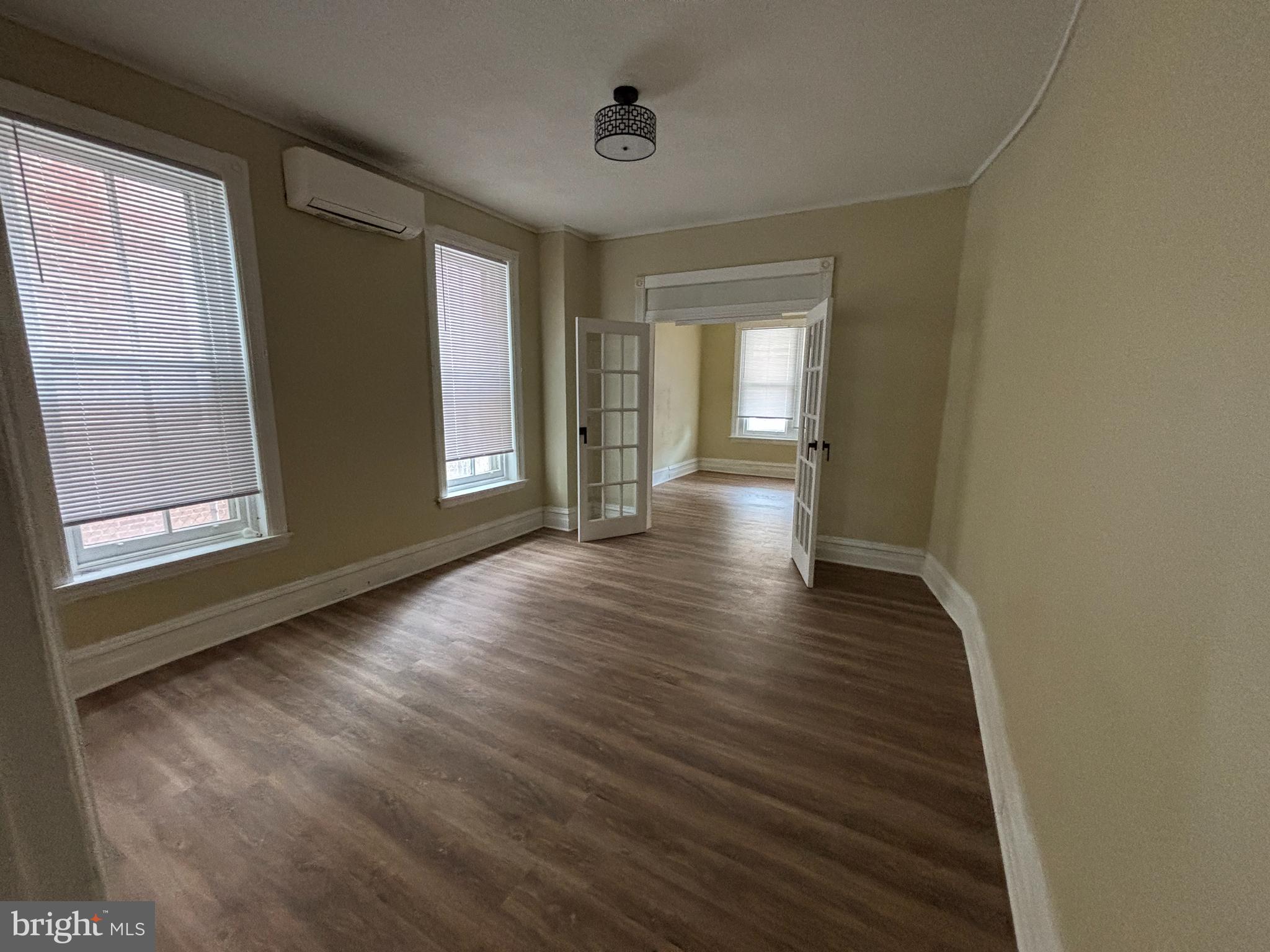 130 East 4th Street, Unit 1 Pottstown, PA 19464 - Photo 8 of 12 a view of an empty room with wooden floor and a window