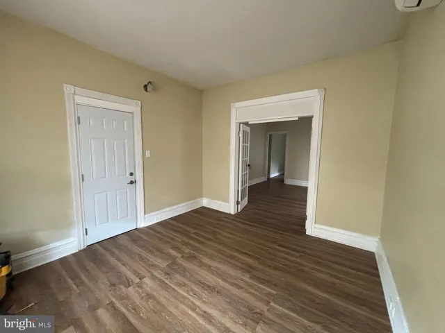 a view of hallway with wooden floor