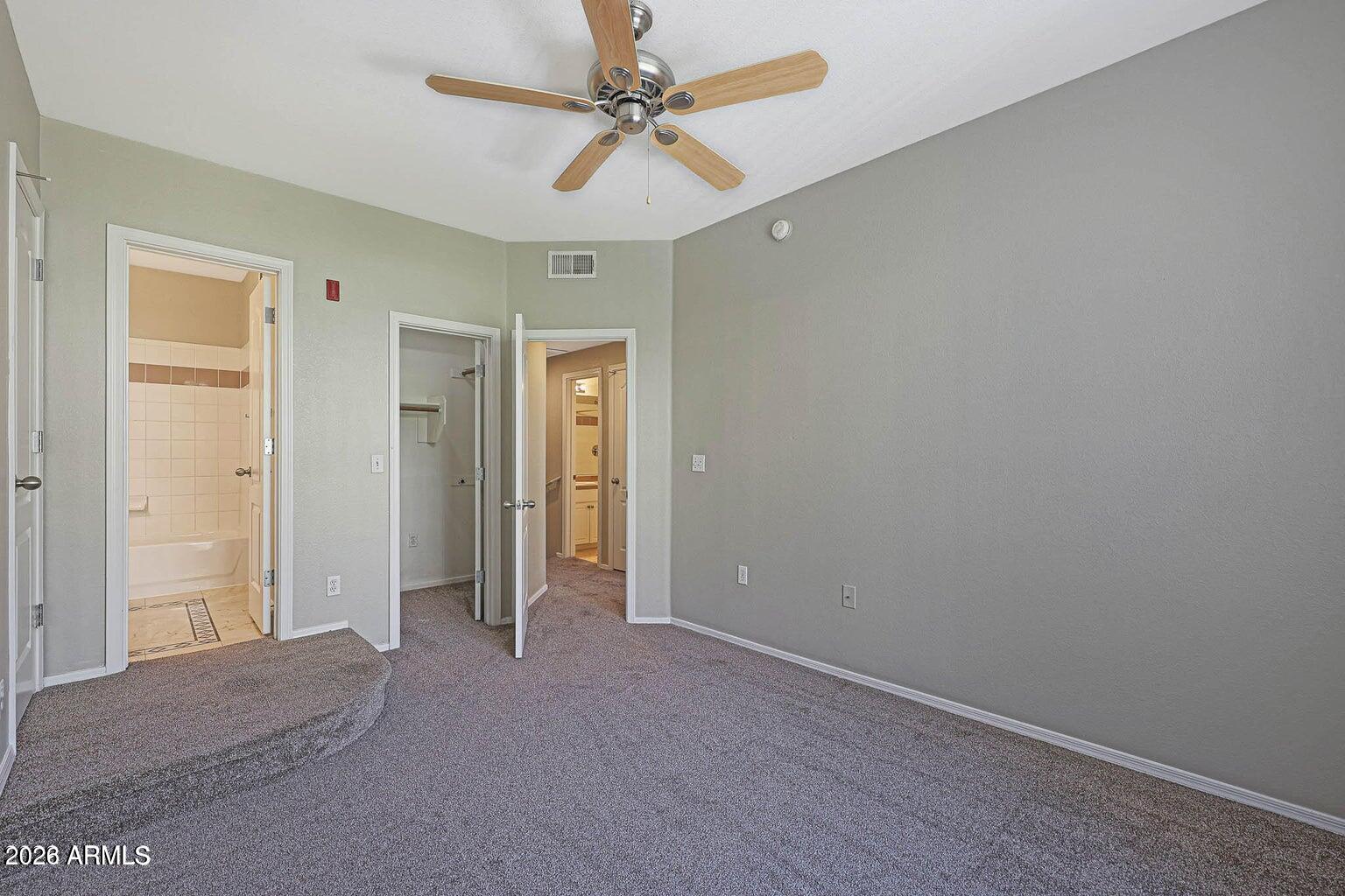 1701 East Colter Street, Unit 11 Phoenix, AZ 85016 - Photo 16 of 31 an empty room with closet and a ceiling fan