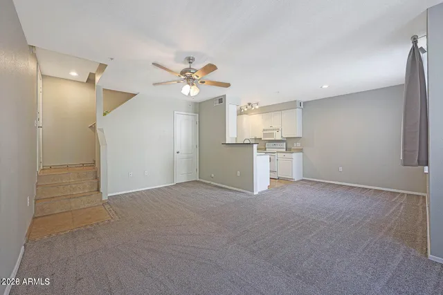 an empty room with a kitchen and a sink
