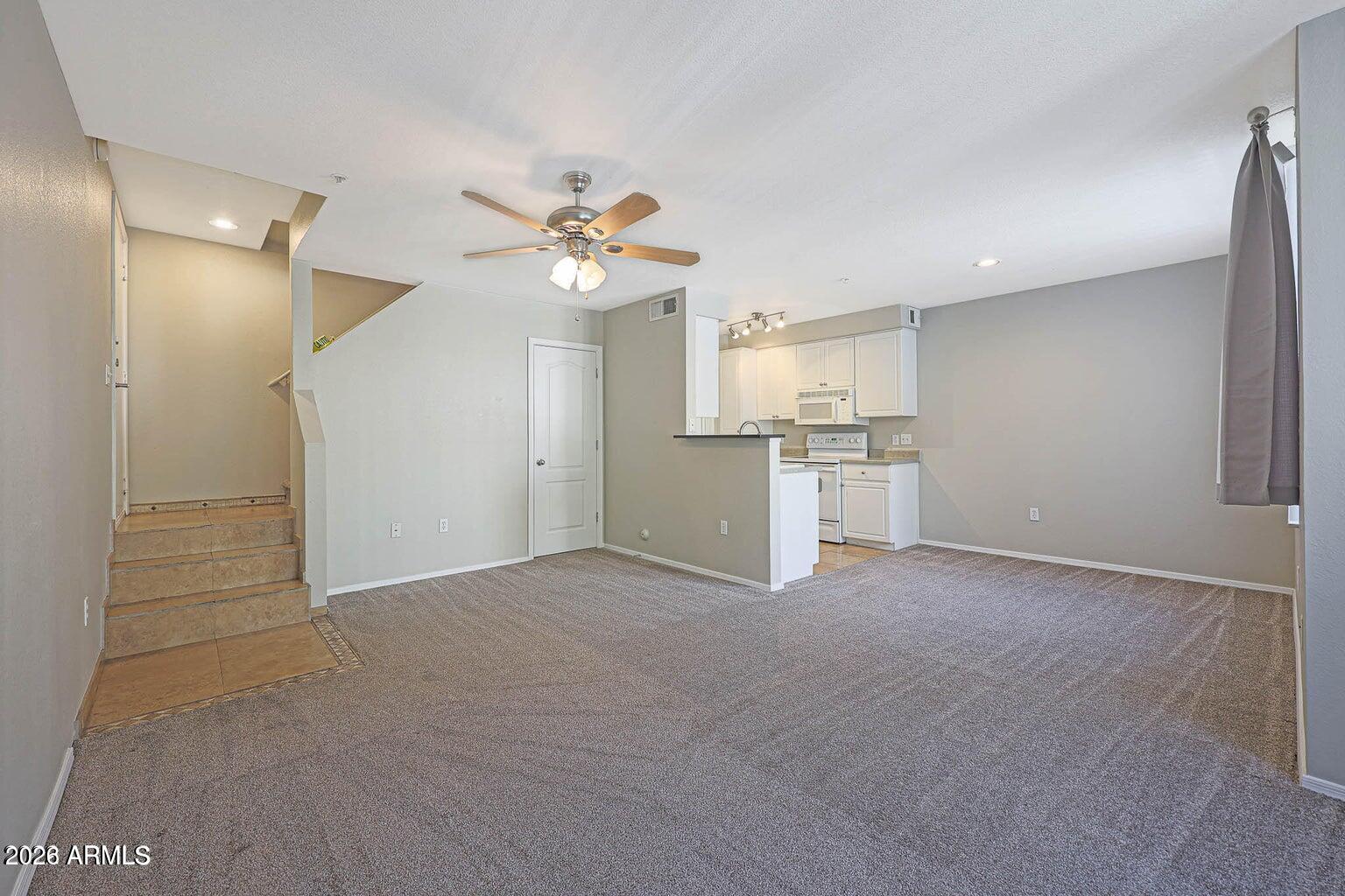 1701 East Colter Street, Unit 11 Phoenix, AZ 85016 - Photo 2 of 31 an empty room with a kitchen and a sink