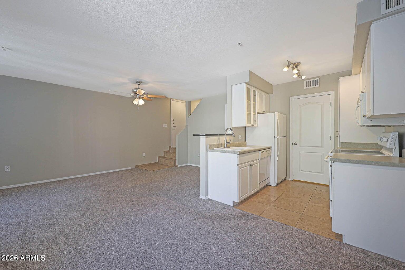 1701 East Colter Street, Unit 11 Phoenix, AZ 85016 - Photo 4 of 31 a view of a kitchen with white cabinets