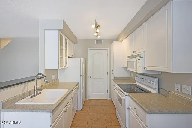 a kitchen with a sink stove and refrigerator