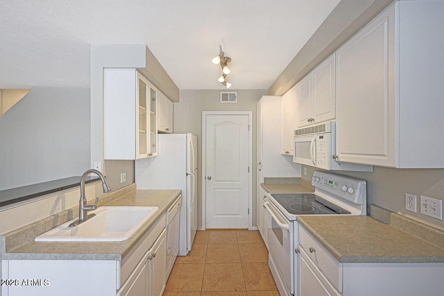 1701 East Colter Street, Unit 11 Phoenix, AZ 85016 - Photo 5 of 31 a kitchen with a sink stove and refrigerator