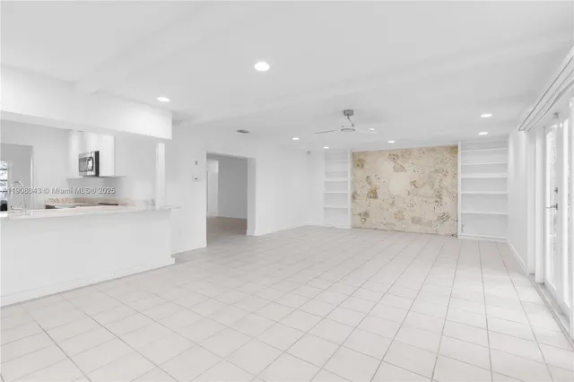 a large white kitchen with white cabinets