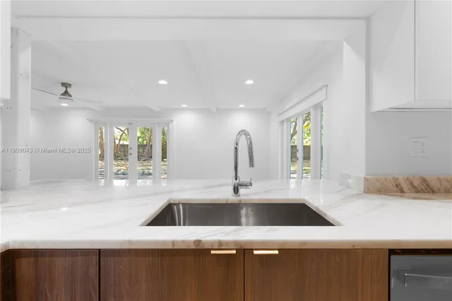 a kitchen with a sink a counter space and a window