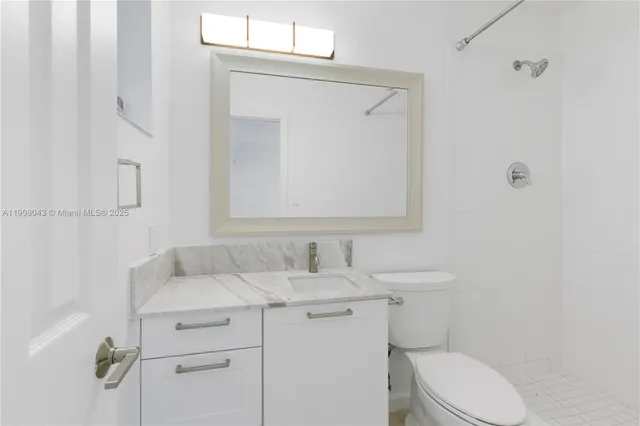 a bathroom with a sink toilet and mirror