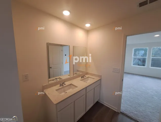 a bathroom with a sink double vanity and a mirror