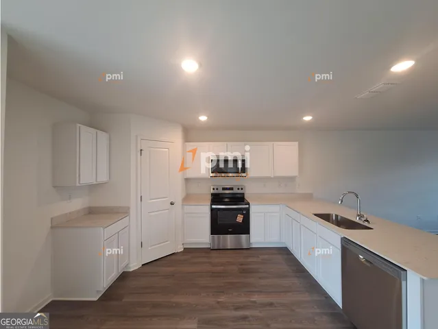 a large kitchen with cabinets and stainless steel appliances