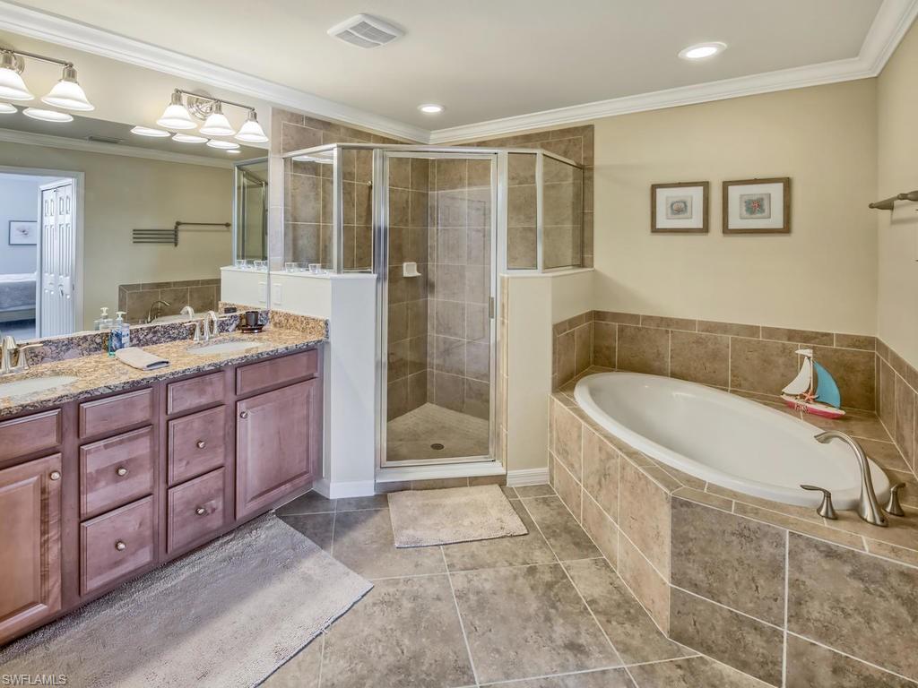 9114 Prima Way, Unit 102 Naples, FL 34113 - Photo 11 of 33 a spacious bathroom with a tub shower and sink