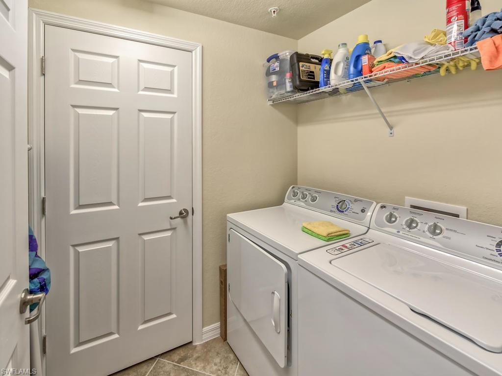 9114 Prima Way, Unit 102 Naples, FL 34113 - Photo 18 of 33 a utility room with dryer and washer