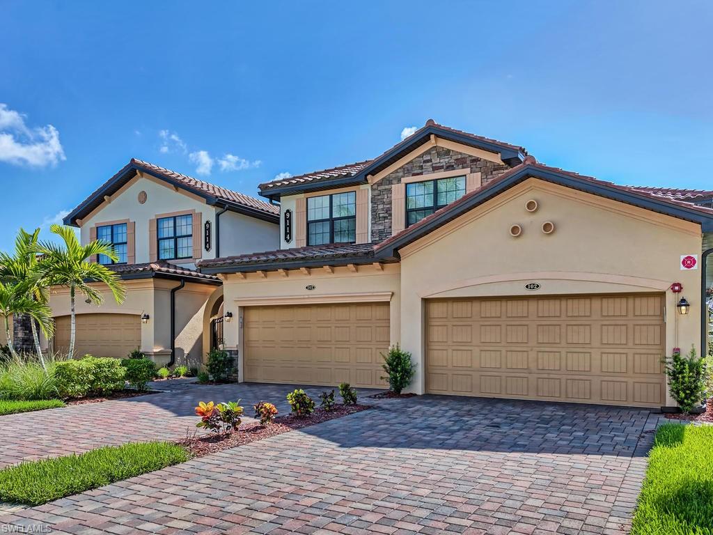9114 Prima Way, Unit 102 Naples, FL 34113 - Photo 2 of 33 a front view of a house with garden