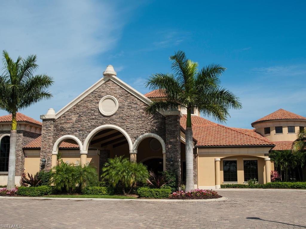 9114 Prima Way, Unit 102 Naples, FL 34113 - Photo 28 of 33 a front view of a house with plants and trees