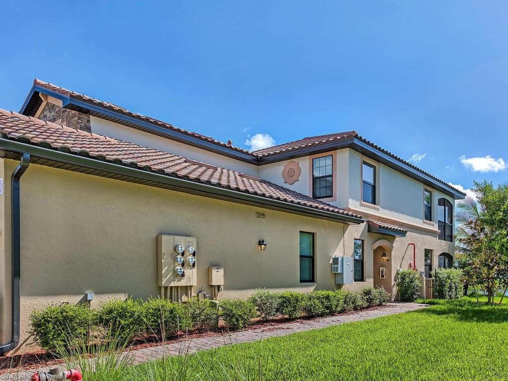 9114 Prima Way, Unit 102 Naples, FL 34113 - Photo 3 of 33 a view of a house with a yard
