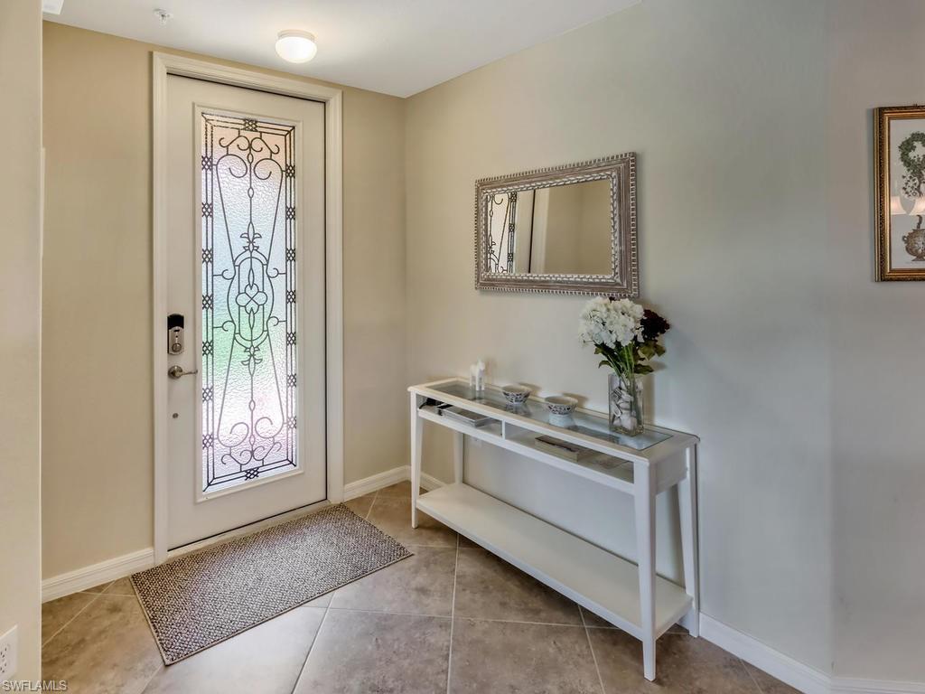 9114 Prima Way, Unit 102 Naples, FL 34113 - Photo 4 of 33 a view of a hallway with entryway and dining room