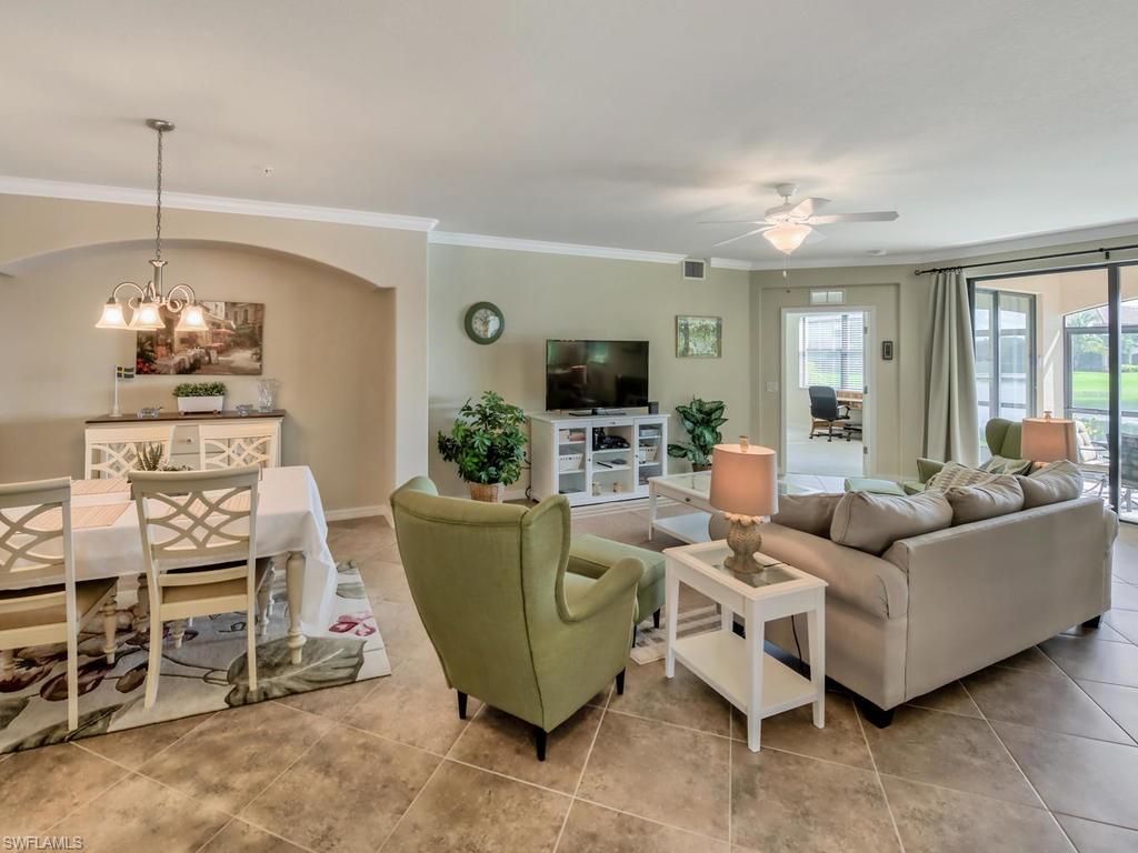 9114 Prima Way, Unit 102 Naples, FL 34113 - Photo 5 of 33 a living room with furniture and a chandelier
