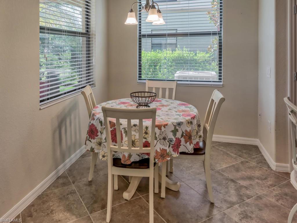 9114 Prima Way, Unit 102 Naples, FL 34113 - Photo 8 of 33 a dining room with furniture and window