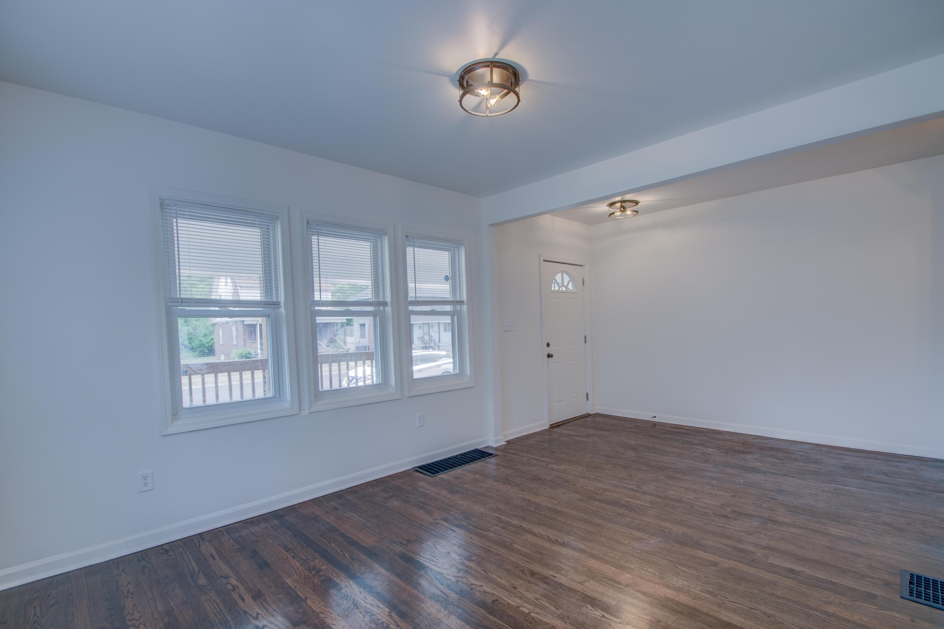613 Tennessee Street Gary, IN 46402 - Photo 18 of 39 an empty room with wooden floor and windows