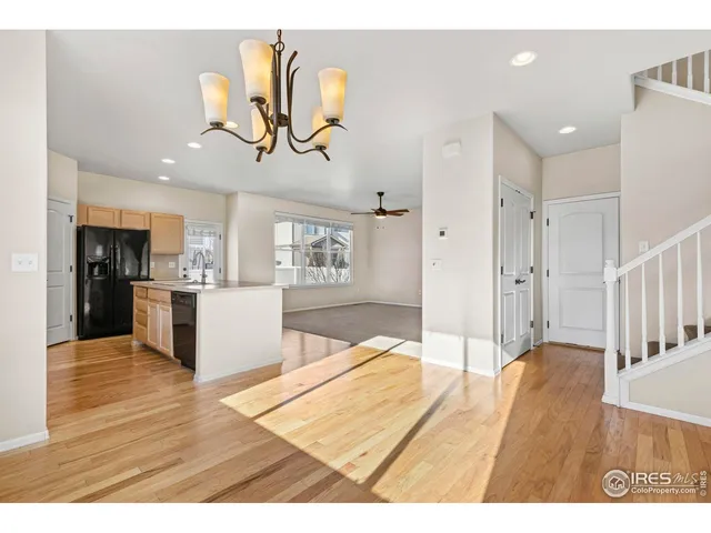 a view interior of kitchen and hall with wooden floor