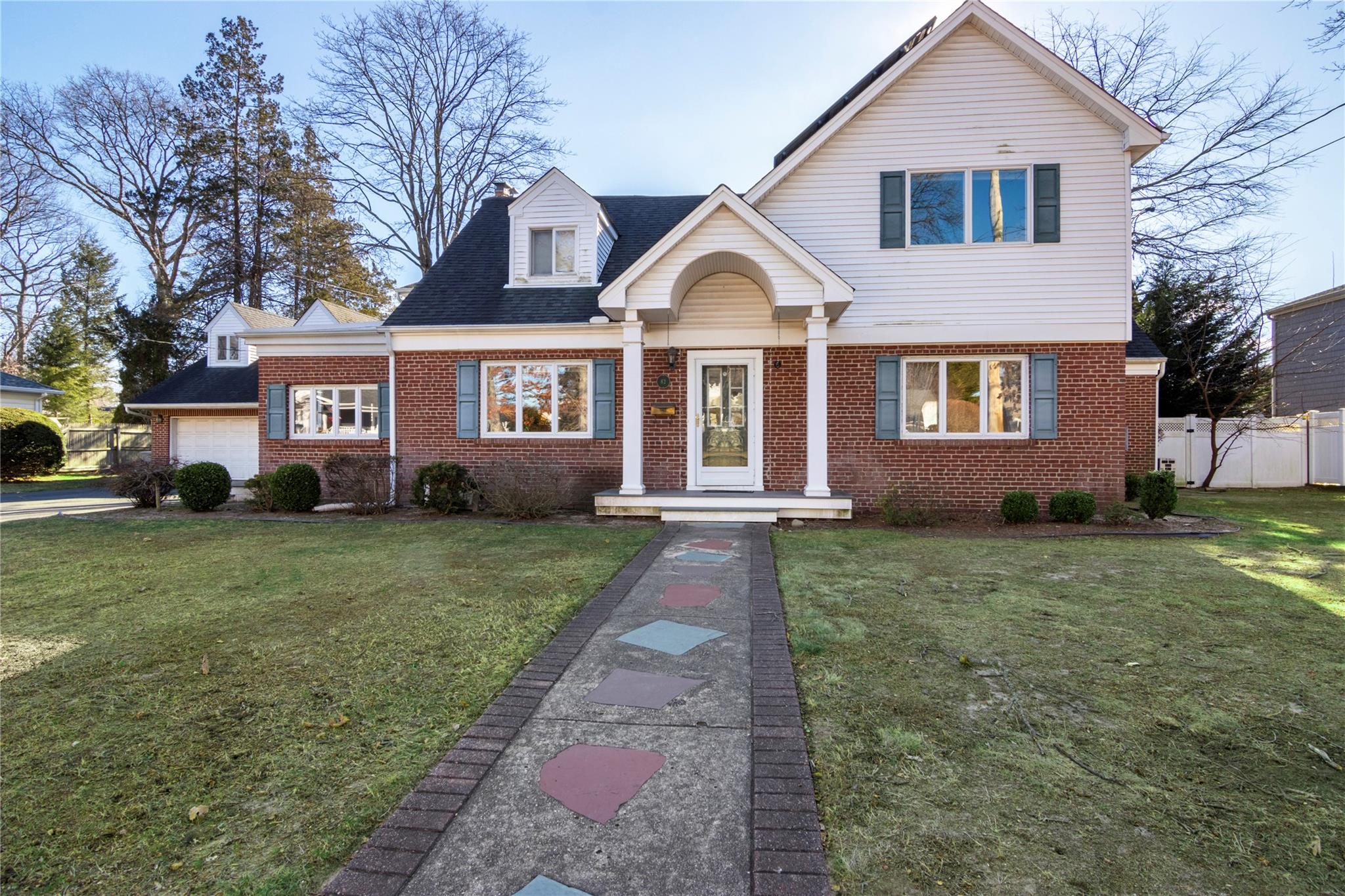 82 Ketewamoke Avenue Babylon, NY 11702 - Photo 1 of 1 a front view of a house with a garden