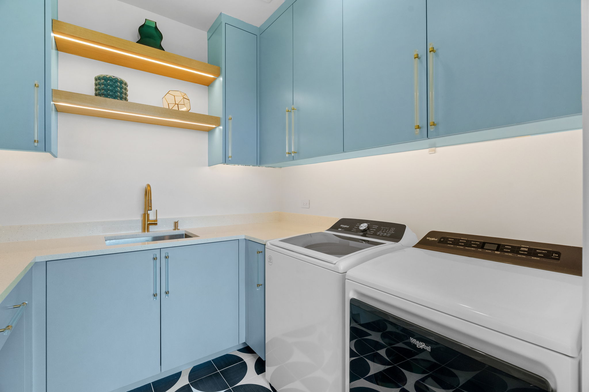 503 Happy Trail Dripping Springs, TX 78620 - Photo 20 of 38 Laundry space featuring light blue cabinetry, built-in sink with brass-finish faucet, under-cabinet lighting, and illuminated wood-finish shelving