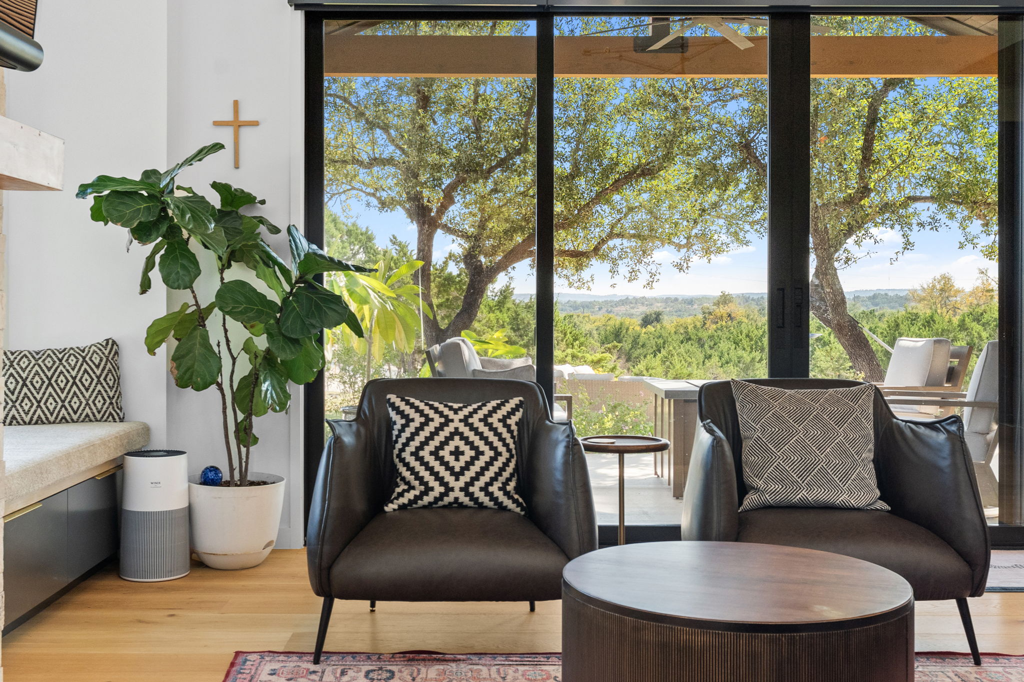503 Happy Trail Dripping Springs, TX 78620 - Photo 3 of 38 Expansive glass sliding doors open to an outdoor space and distant tree-lined scenery
