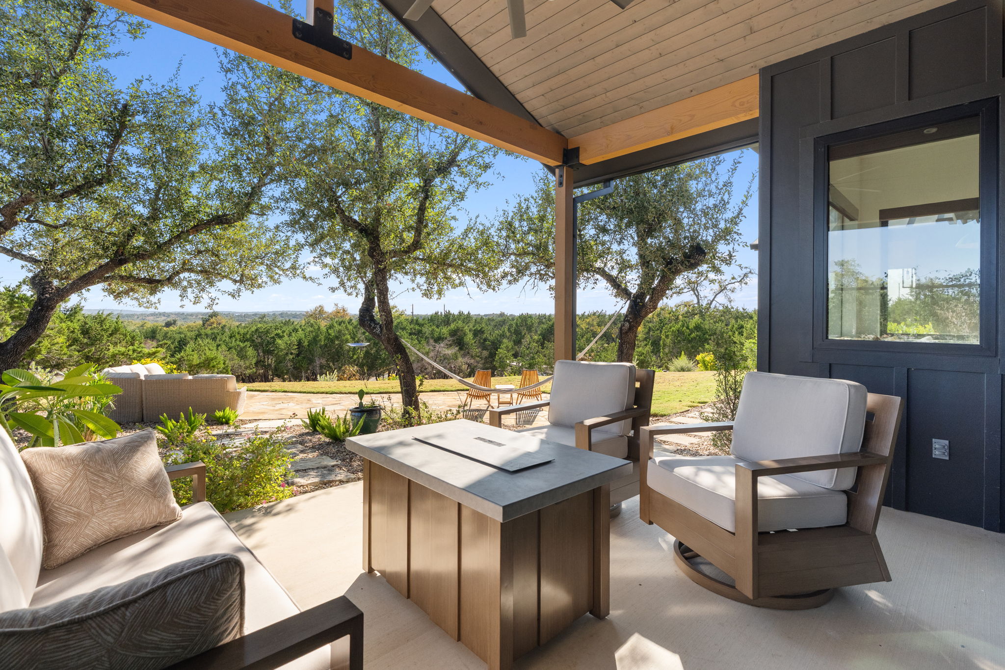 503 Happy Trail Dripping Springs, TX 78620 - Photo 33 of 38 Covered patio with a high vaulted ceiling and exposed wood beams