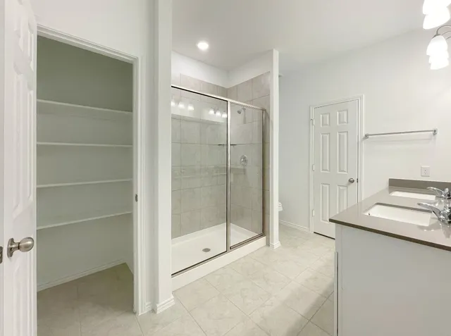 a bathroom with a shower and a sink
