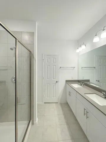a view of a bathroom with a sink and mirror