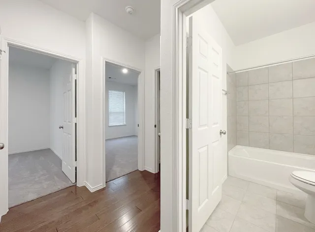 a bathroom with a bathtub and a shower