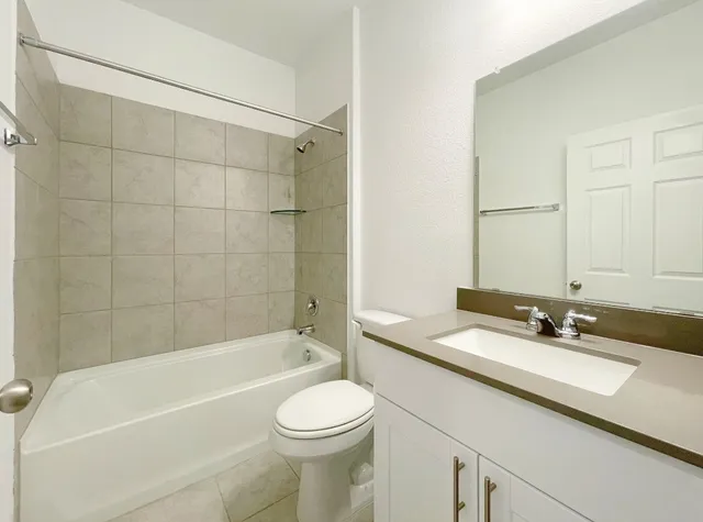 a bathroom with a sink a toilet and bathtub