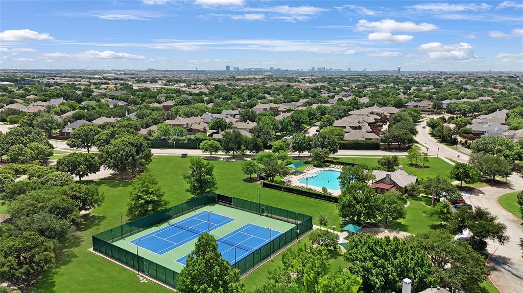 960 Remuda Road Frisco, TX 75033 - Photo 35 of 39 Aerial perspective showcasing a community park with expansive green space, two tennis courts, and a swimming pool area